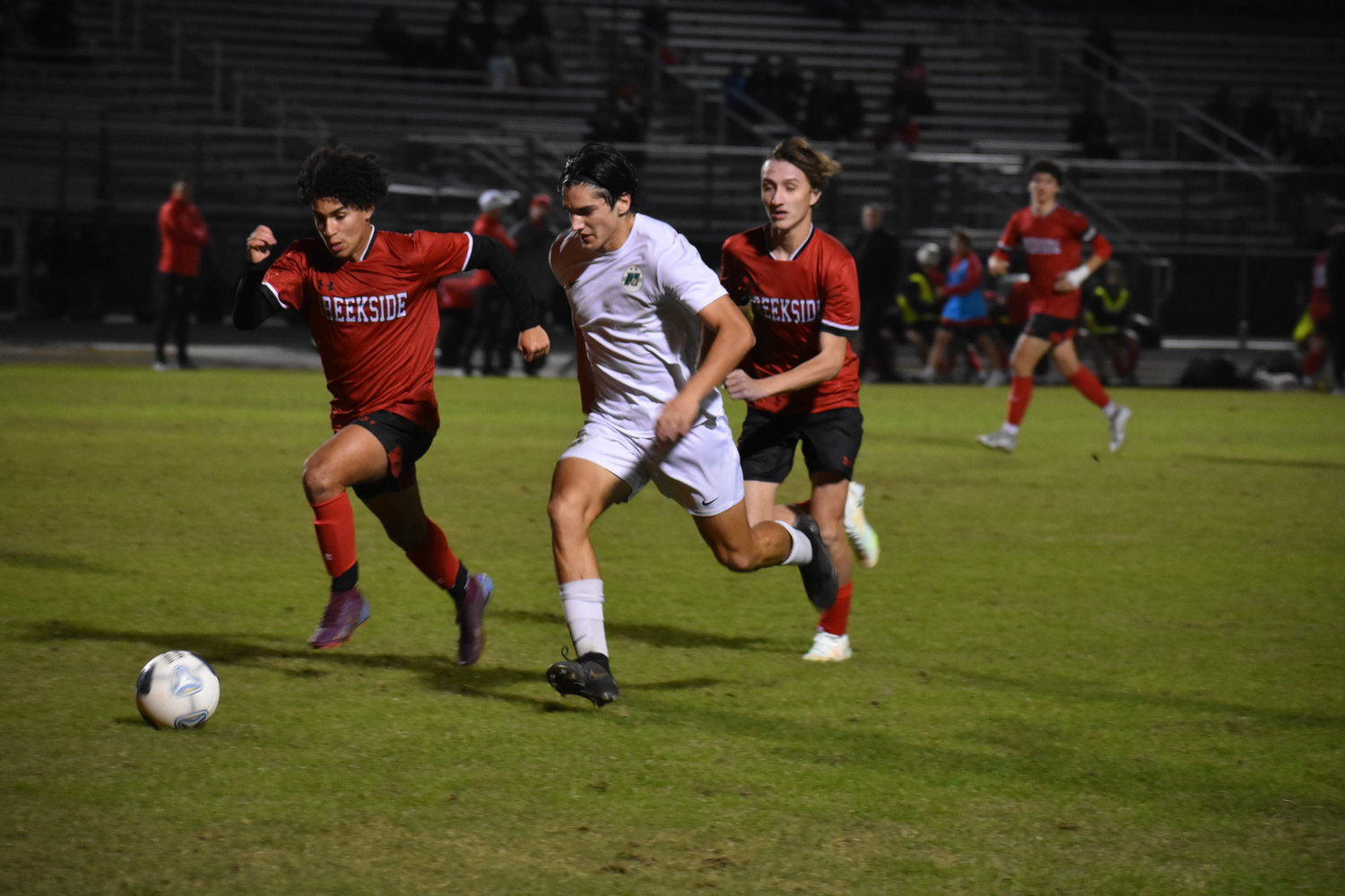 Nease senior Brogan Donnelly slices through a pair of Creekside defenders. He scored both Panthers’ goals on the night.